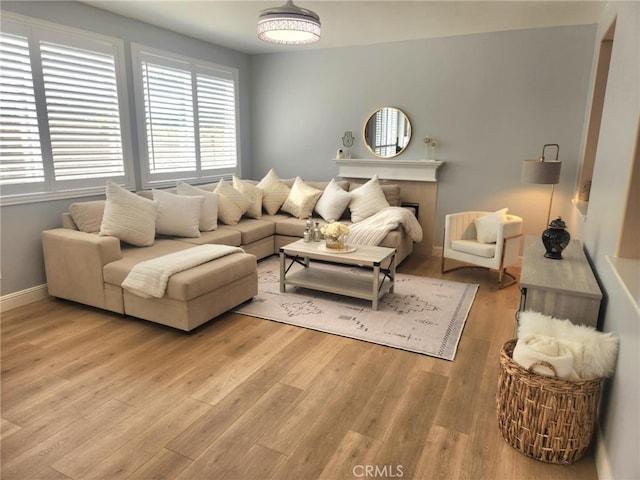 26523 Starling Ct, Canyon Country, CA 91387 - living room with healthy amount of natural light, light wood-type flooring, and a fireplace