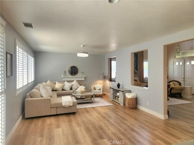26523 Starling Ct, Canyon Country, CA 91387 - living area featuring light wood-style flooring and baseboards