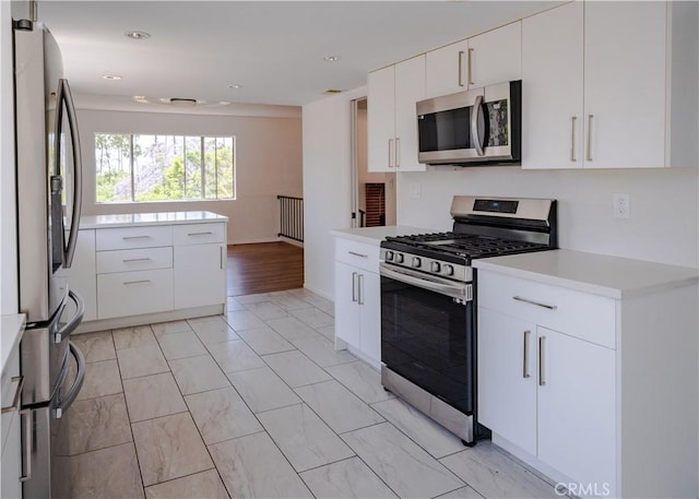 1522 N Benton Way, Los Angeles, CA 90026 - kitchen with stainless steel appliances, light countertops, white cabinetry, recessed lighting, and light marble finish floors