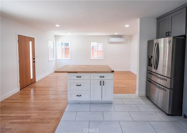 1522 N Benton Way, Los Angeles, CA 90026 - kitchen with stainless steel refrigerator with ice dispenser, a wall mounted AC, butcher block counters, light wood-style floors, and recessed lighting