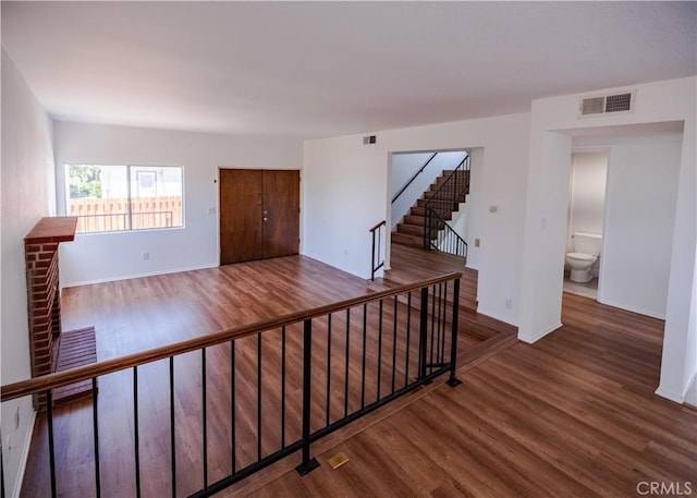1522 N Benton Way, Los Angeles, CA 90026 - unfurnished room with wood finished floors and stairs