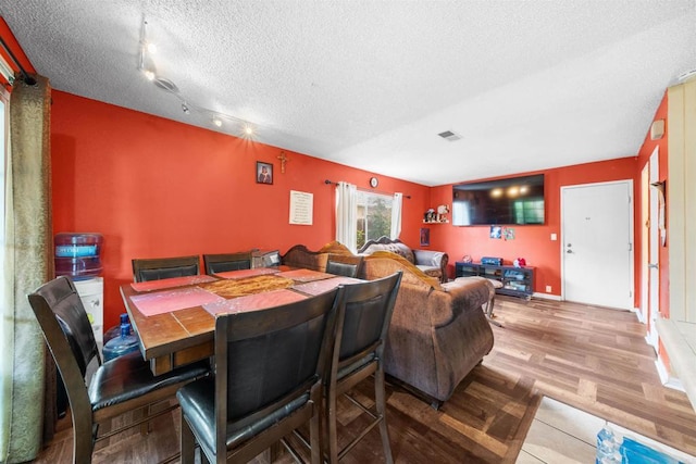 1861 Katella St, San Diego, CA 92154 - dining room with a textured ceiling, wood finished floors, and track lighting