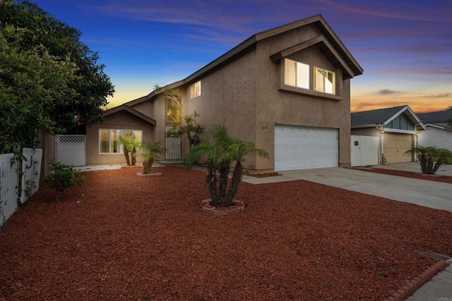 1861 Katella St, San Diego, CA 92154 - view of front facade featuring stucco siding, an attached garage, and concrete driveway