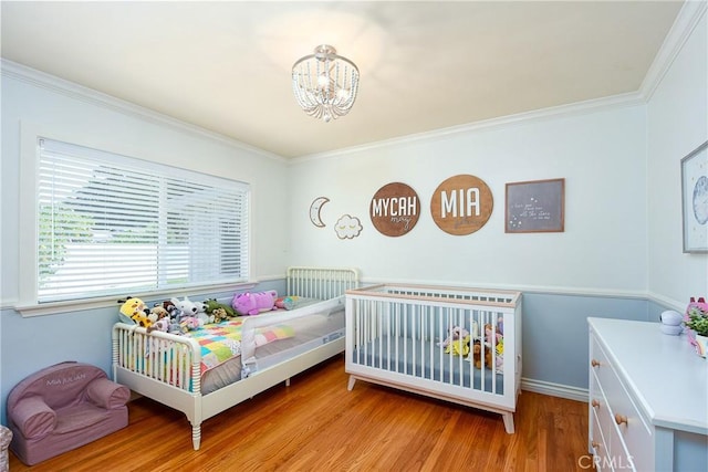 7311 Westwood Dr, Riverside, CA 92504 - bedroom featuring ornamental molding, light wood-style floors, and a chandelier