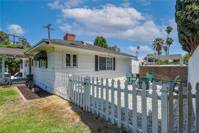 7311 Westwood Dr, Riverside, CA 92504 - rear view of property featuring a chimney, a fenced backyard, and a patio