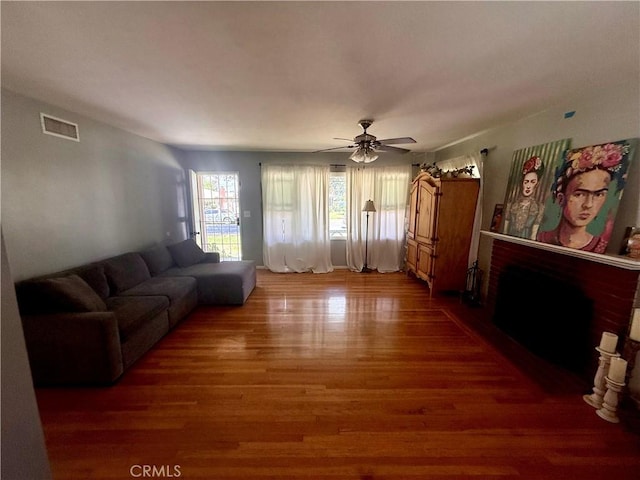 8514 Hickory Ln, Riverside, CA 92504 - living room featuring a brick fireplace, wood finished floors, and ceiling fan