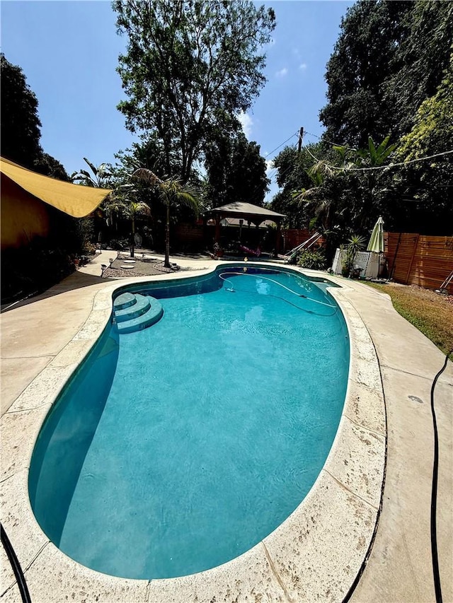 8514 Hickory Ln, Riverside, CA 92504 - view of swimming pool featuring a gazebo, a fenced backyard, and a patio area