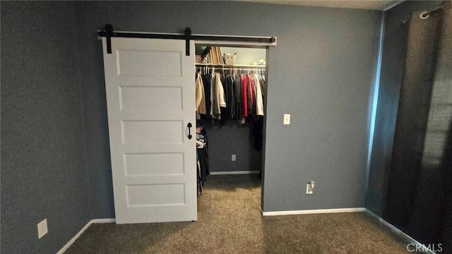 8514 Hickory Ln, Riverside, CA 92504 - unfurnished bedroom with a closet, carpet, a spacious closet, and a barn door