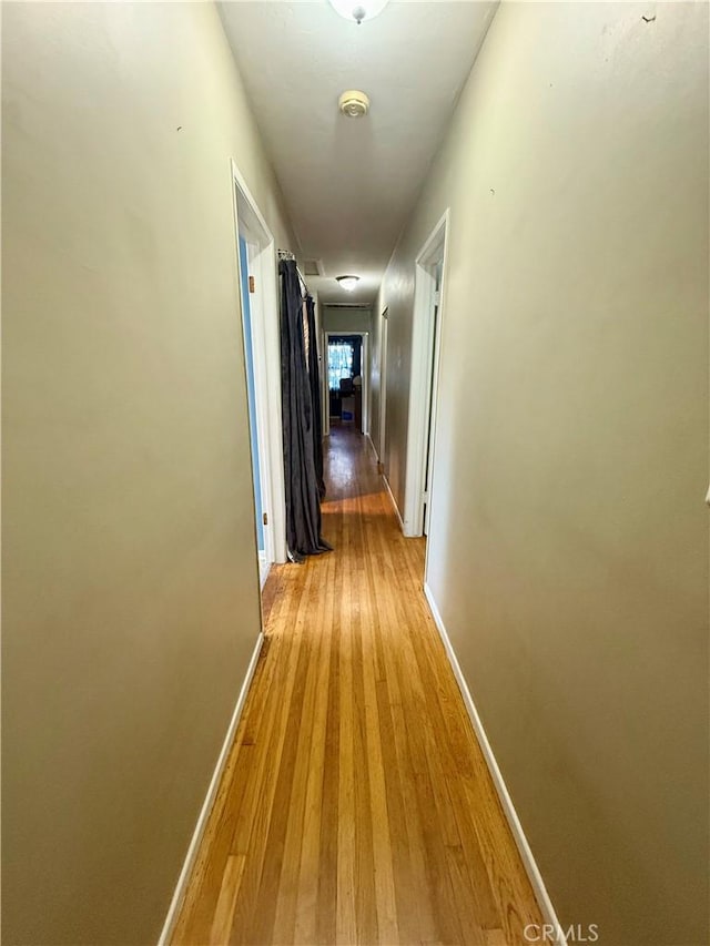 8514 Hickory Ln, Riverside, CA 92504 - hallway with light wood-style flooring and baseboards