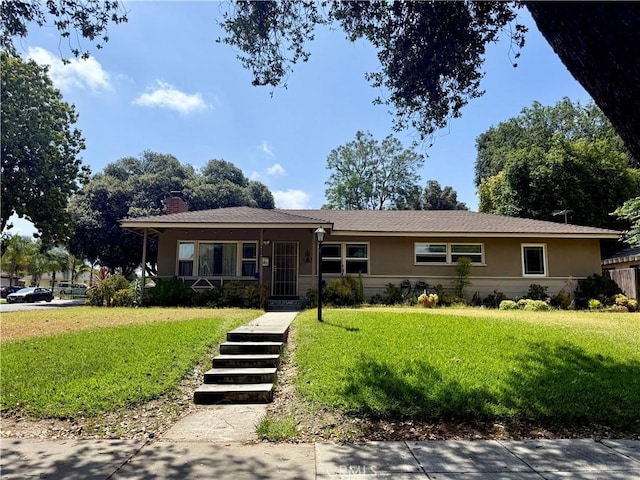 8514 Hickory Ln, Riverside, CA 92504 - view of front of property with a front yard, a chimney, and stucco siding