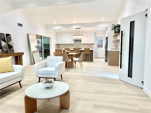 10335 Babbitt Ave, Granada Hills, CA 91344 - living area featuring light wood-type flooring, lofted ceiling, and recessed lighting