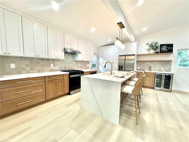 10335 Babbitt Ave, Granada Hills, CA 91344 - kitchen featuring range with gas stovetop, stainless steel fridge with ice dispenser, wine cooler, under cabinet range hood, and light wood-style flooring