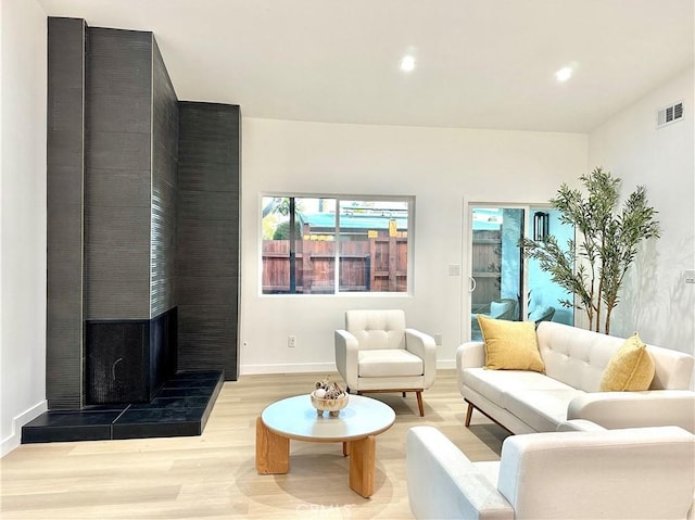 10335 Babbitt Ave, Granada Hills, CA 91344 - living room featuring light wood-style flooring, recessed lighting, and a tiled fireplace