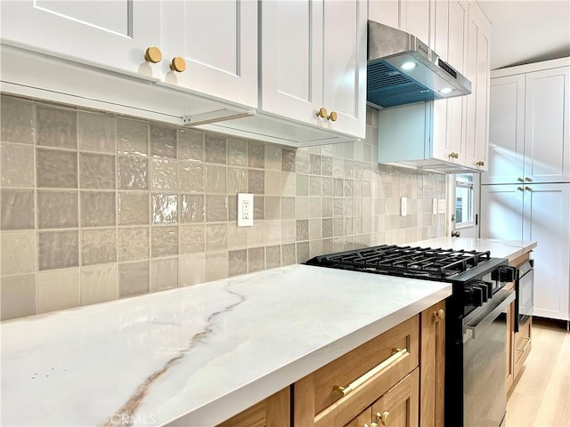 10335 Babbitt Ave, Granada Hills, CA 91344 - kitchen featuring black gas stove, range hood, light wood-style floors, backsplash, and white cabinets