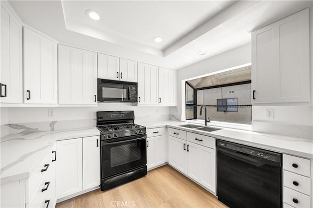 5510 Las Virgenes Rd, Calabasas, CA 91302 - kitchen with black appliances, recessed lighting, a raised ceiling, and white cabinetry
