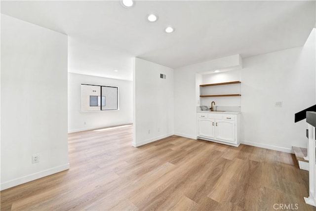 5510 Las Virgenes Rd, Calabasas, CA 91302 - unfurnished living room with light wood-style flooring, recessed lighting, and wet bar