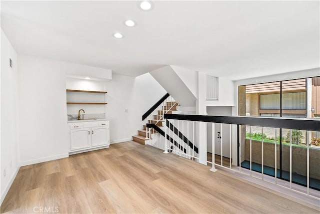 5510 Las Virgenes Rd, Calabasas, CA 91302 - hallway featuring recessed lighting, light wood-type flooring, and stairs