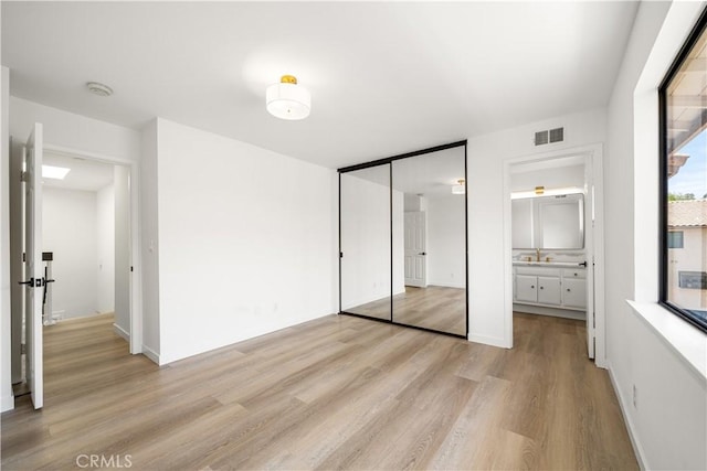 5510 Las Virgenes Rd, Calabasas, CA 91302 - unfurnished bedroom featuring light wood-style floors, a closet, and ensuite bath