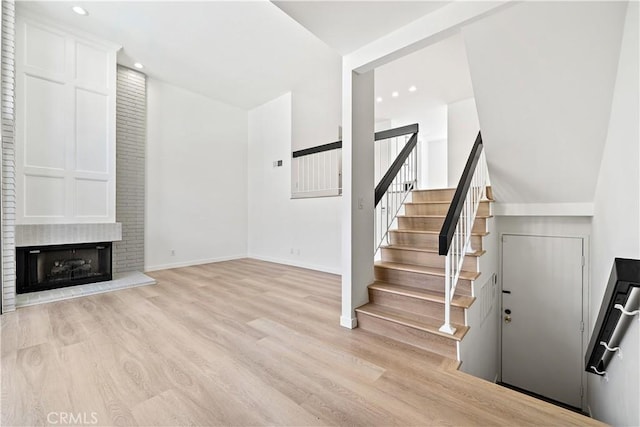 5510 Las Virgenes Rd, Calabasas, CA 91302 - stairway with wood finished floors, recessed lighting, and a large fireplace