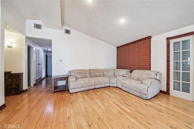 2148 W Houston Ave, Fullerton, CA 92833 - living area with lofted ceiling, light wood finished floors, and a textured ceiling