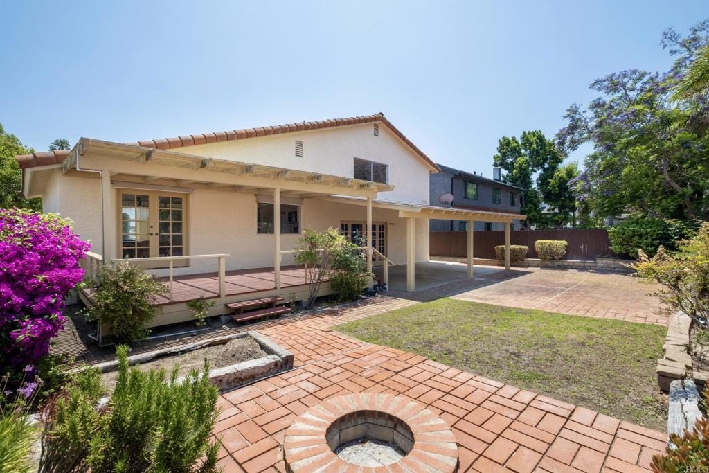 268 Chapalita Dr, Encinitas, CA 92024 - rear view of property with an outdoor fire pit, french doors, a patio area, stucco siding, and a deck