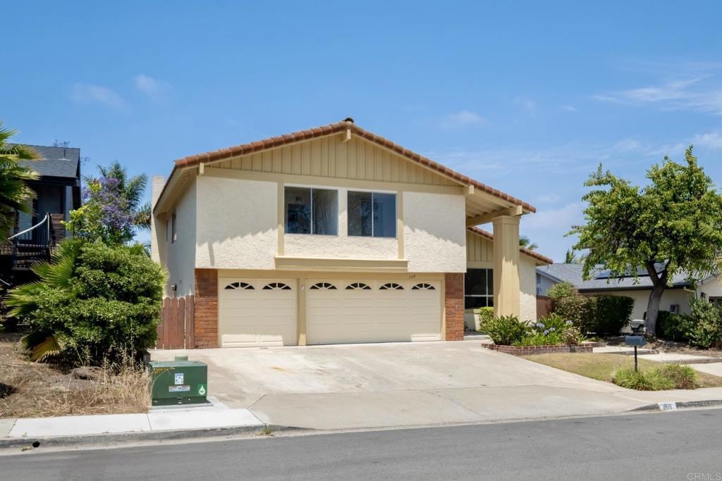 268 Chapalita Dr, Encinitas, CA 92024 - traditional home with a garage, concrete driveway, stucco siding, a tile roof, and brick siding