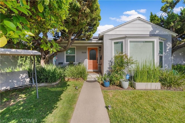 15018 Mankato St, Mission Hills San Fernando, CA 91345 - view of front of house featuring a front lawn and stucco siding