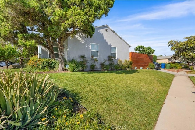 15018 Mankato St, Mission Hills San Fernando, CA 91345 - view of side of home with a lawn and stucco siding
