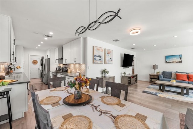 15018 Mankato St, Mission Hills San Fernando, CA 91345 - dining space with light wood-style floors and recessed lighting