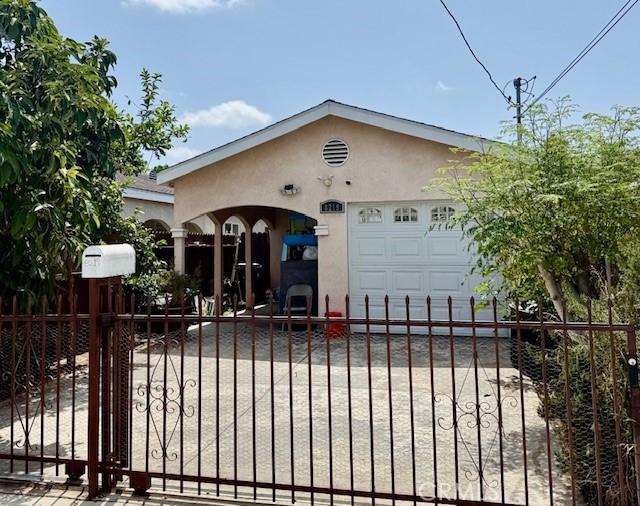 8219 Crockett Blvd, Los Angeles, CA 90001 - view of front of property with stucco siding, a gate, and an attached garage
