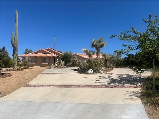 59019 Pueblo Trl, Yucca Valley, CA 92284 - view of front of property with a tiled roof, concrete driveway, and stucco siding