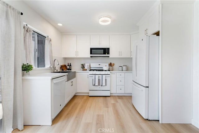 10 Eastmont, Irvine, CA 92604 - kitchen with white appliances, light wood-style flooring, white cabinetry, light countertops, and recessed lighting