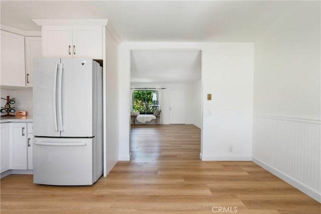 10 Eastmont, Irvine, CA 92604 - kitchen featuring freestanding refrigerator, white cabinets, light wood-style flooring, and wainscoting