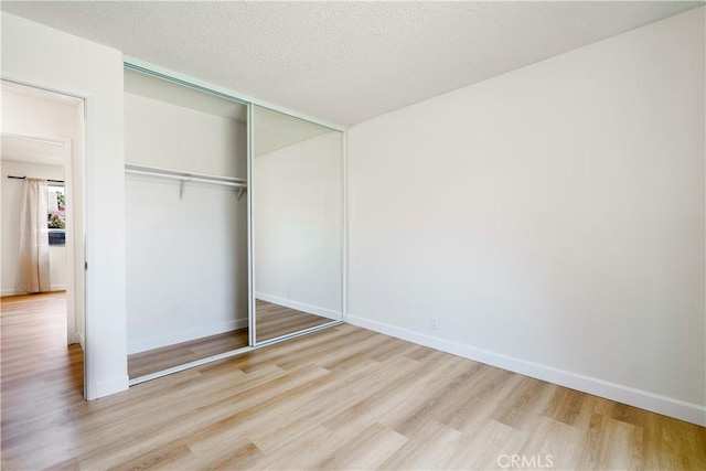 10 Eastmont, Irvine, CA 92604 - unfurnished bedroom with wood finished floors, a closet, and a textured ceiling