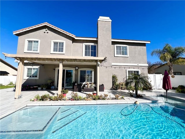 1539 Carmel Ct, Redlands, CA 92374 - back of house featuring stucco siding, a patio, a chimney, and a tiled roof