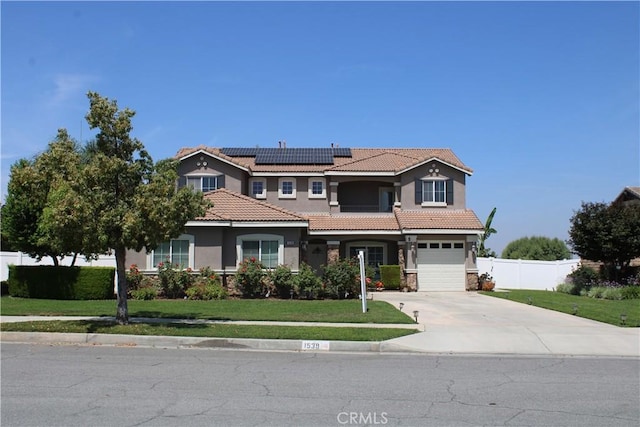 1539 Carmel Ct, Redlands, CA 92374 - view of front of house with a tiled roof, driveway, solar panels, stucco siding, and an attached garage