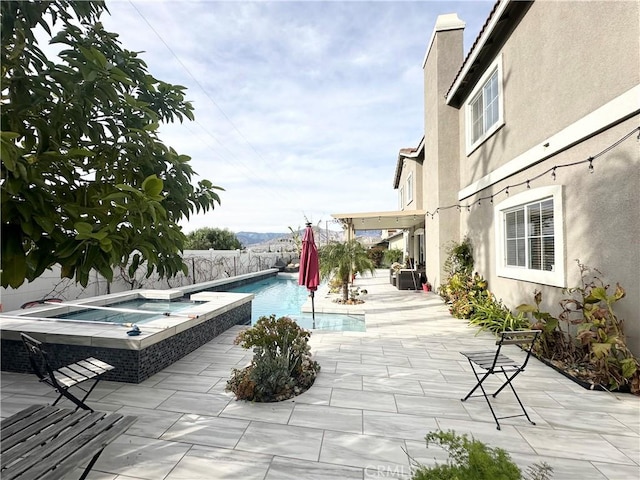 1539 Carmel Ct, Redlands, CA 92374 - view of pool with a fenced backyard, a pool with connected hot tub, and a patio area