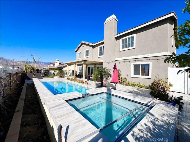 1539 Carmel Ct, Redlands, CA 92374 - view of pool with a fenced backyard, a patio, and a pool with connected hot tub