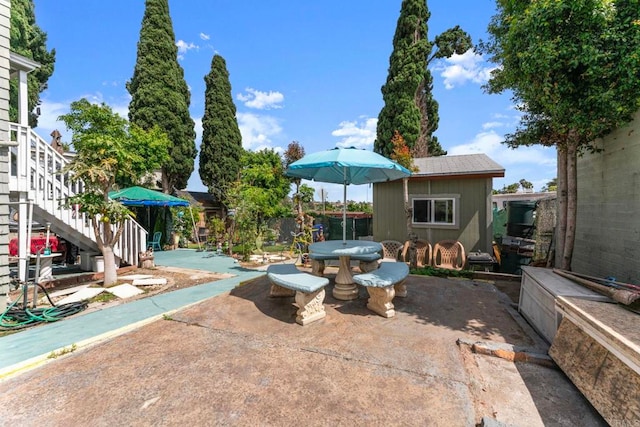 4117 Jamul Ave, San Diego, CA 92113 - view of patio / terrace featuring outdoor dining space, stairs, and a shed