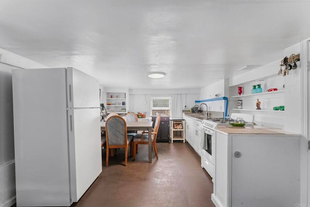 4117 Jamul Ave, San Diego, CA 92113 - kitchen featuring white appliances, open shelves, light countertops, concrete flooring, and white cabinets