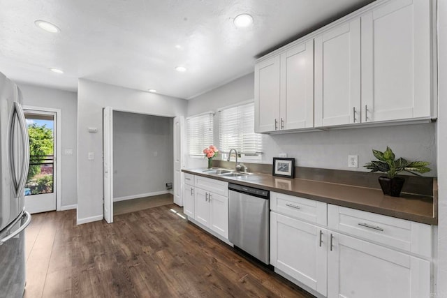 4117 Jamul Ave, San Diego, CA 92113 - kitchen featuring stainless steel appliances, dark countertops, recessed lighting, white cabinetry, and dark wood finished floors