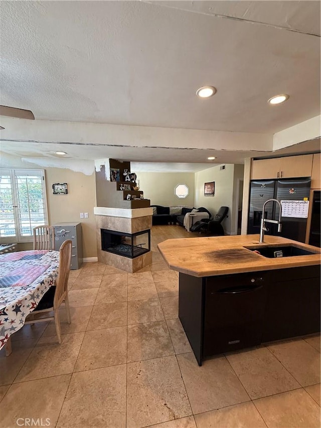 22241 Birchleaf, Mission Viejo, CA 92692 - kitchen featuring light countertops, freestanding refrigerator, light tile patterned flooring, a kitchen island with sink, and open floor plan