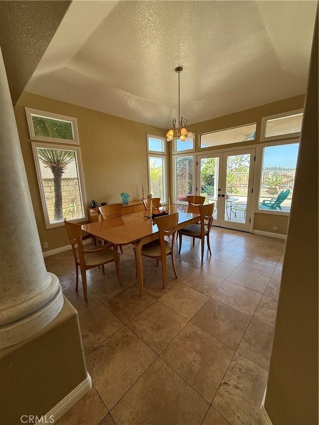 22241 Birchleaf, Mission Viejo, CA 92692 - dining space featuring a textured ceiling, plenty of natural light, a chandelier, and a raised ceiling