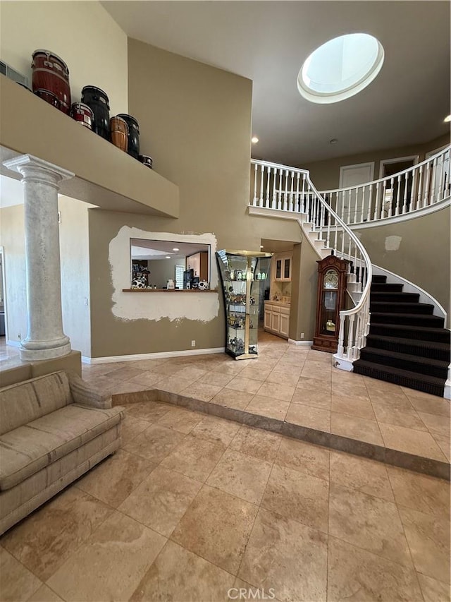 22241 Birchleaf, Mission Viejo, CA 92692 - living room with ornate columns, stairs, inlaid floor details, and a high ceiling