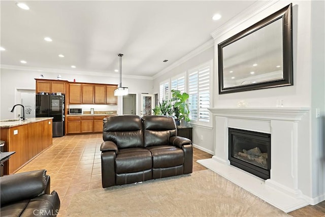 17024 Granite Falls Way, Chowchilla, CA 93610 - living room featuring crown molding, recessed lighting, a glass covered fireplace, and light tile patterned flooring