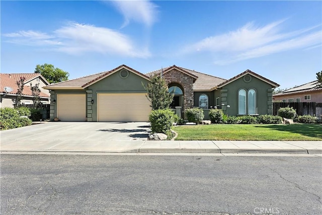 17024 Granite Falls Way, Chowchilla, CA 93610 - view of front of home featuring an attached garage, stucco siding, a tile roof, and concrete driveway