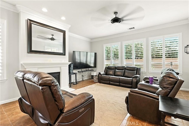 17024 Granite Falls Way, Chowchilla, CA 93610 - tiled living room with a ceiling fan, ornamental molding, a fireplace with raised hearth, and recessed lighting