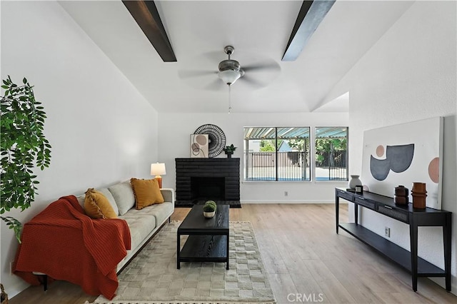 3537 Trinity Ct, Merced, CA 95340 - living area featuring lofted ceiling, light wood-style floors, a ceiling fan, and a fireplace