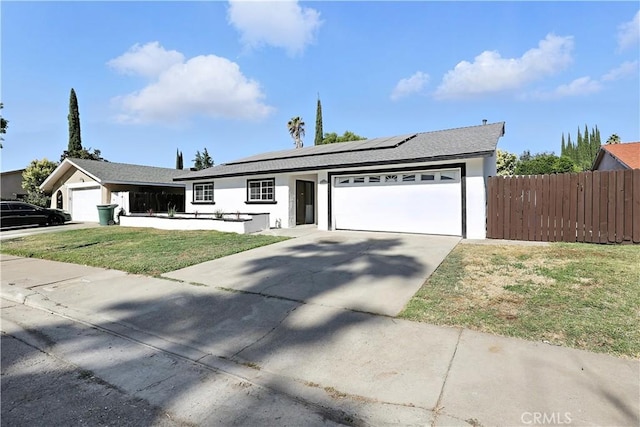 3537 Trinity Ct, Merced, CA 95340 - ranch-style house featuring an attached garage, driveway, solar panels, and stucco siding