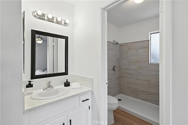 3537 Trinity Ct, Merced, CA 95340 - bathroom with vanity, a tile shower, and wood finished floors